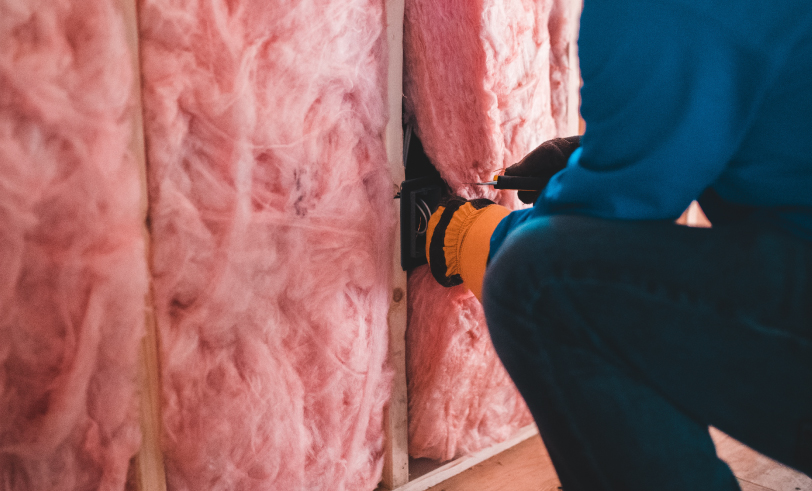 Person insulating a wall